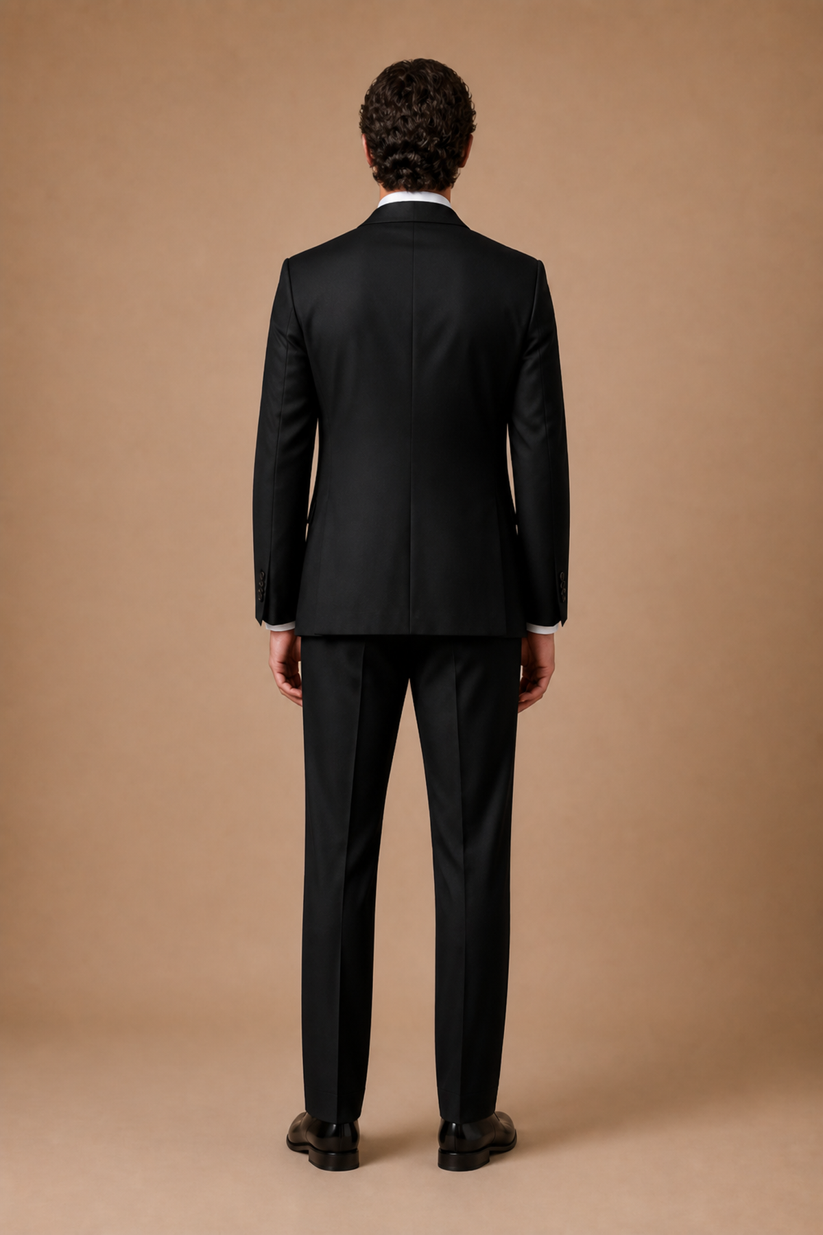 Black modern fit men's tux jacket by Vellor Vault, back view.