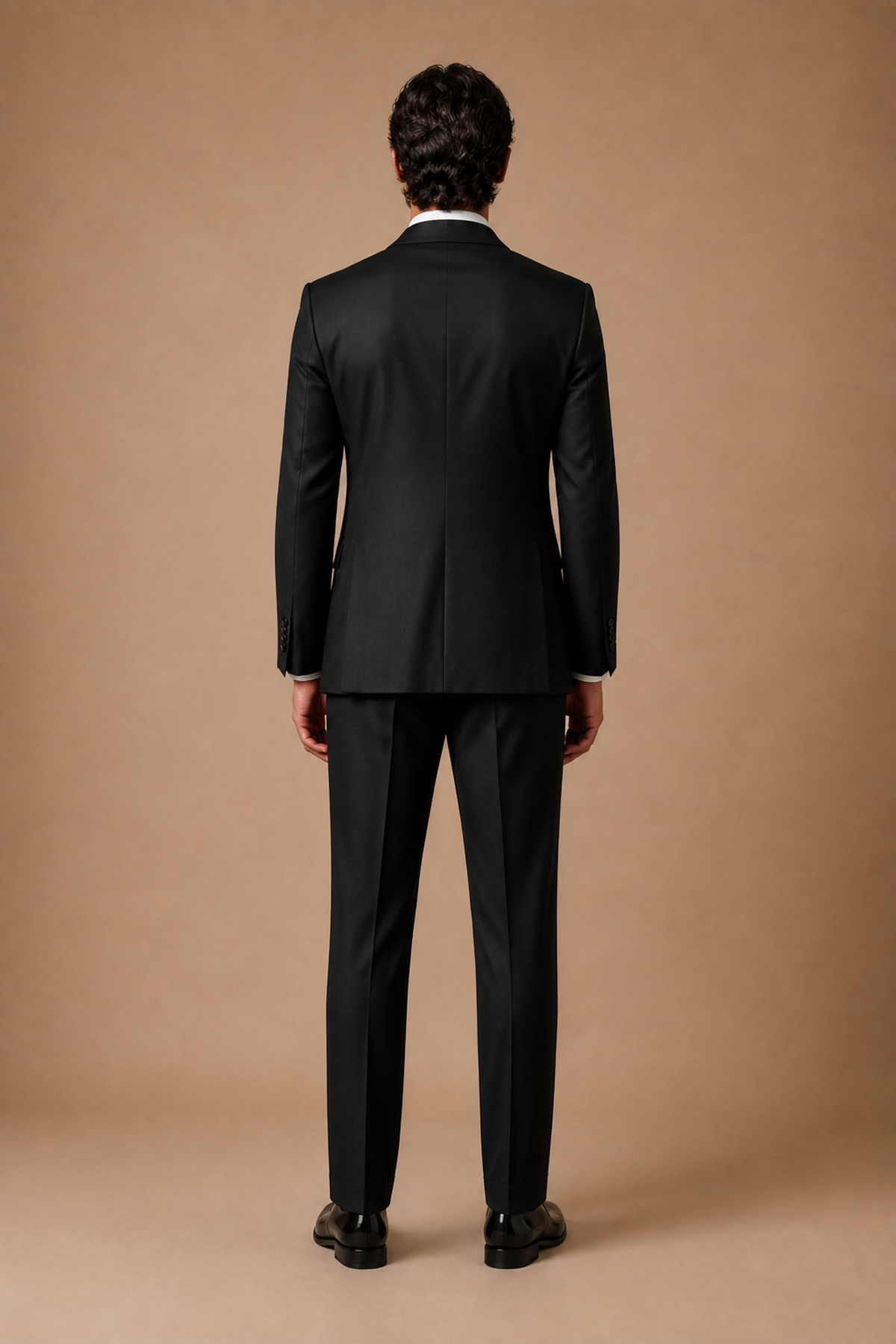 Black modern fit men's tux jacket by Vellor Vault, back view.