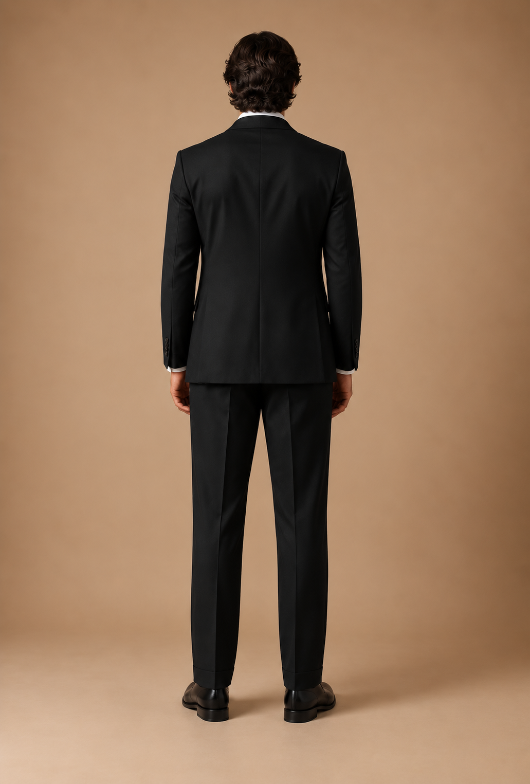 Black modern fit men's suit jacket by Vellor Vault, back view.