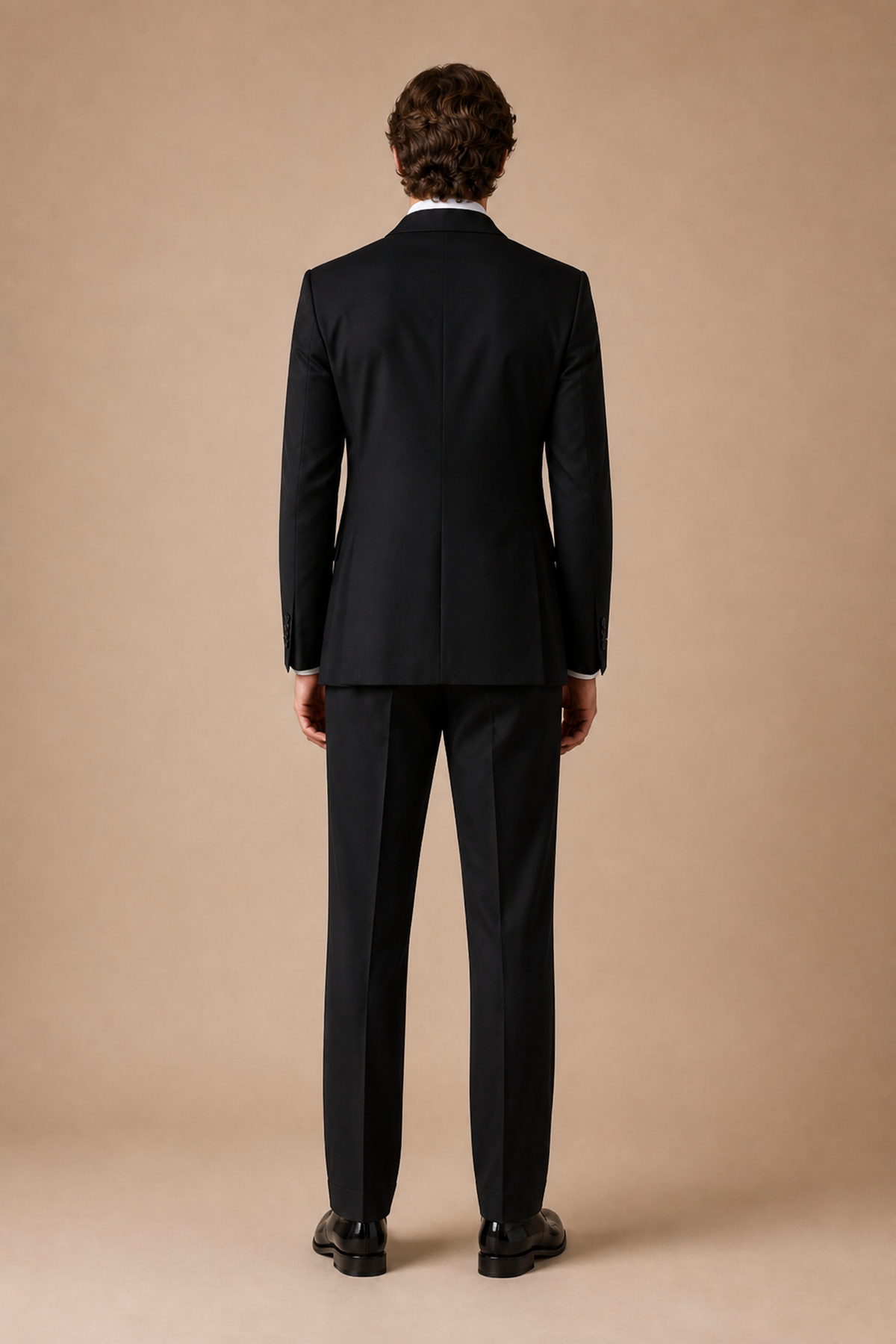 Black modern fit men's tux jacket by Vellor Vault, back view.