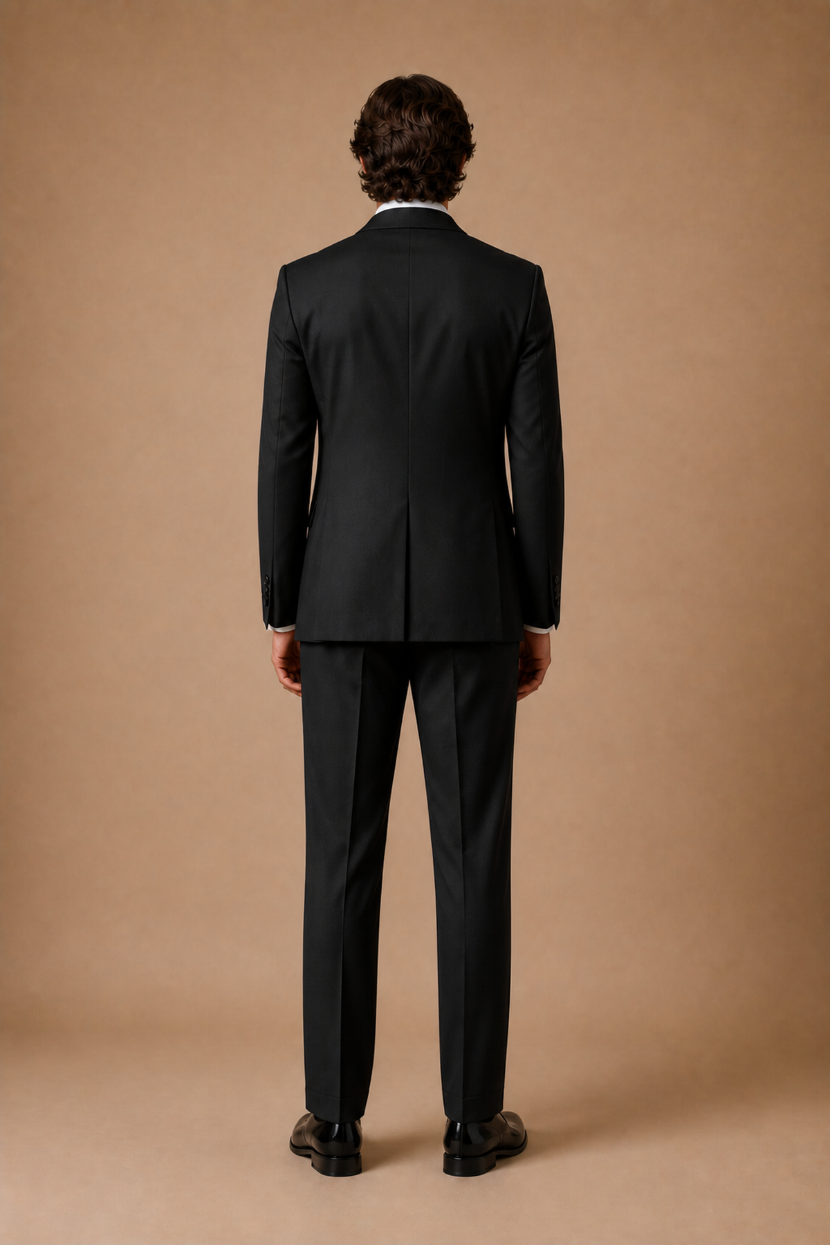Black modern fit men's tux jacket by Vellor Vault, back view.