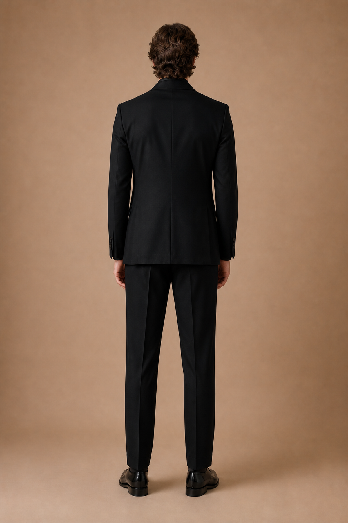Black modern fit men's tux jacket by Vellor Vault, back view.