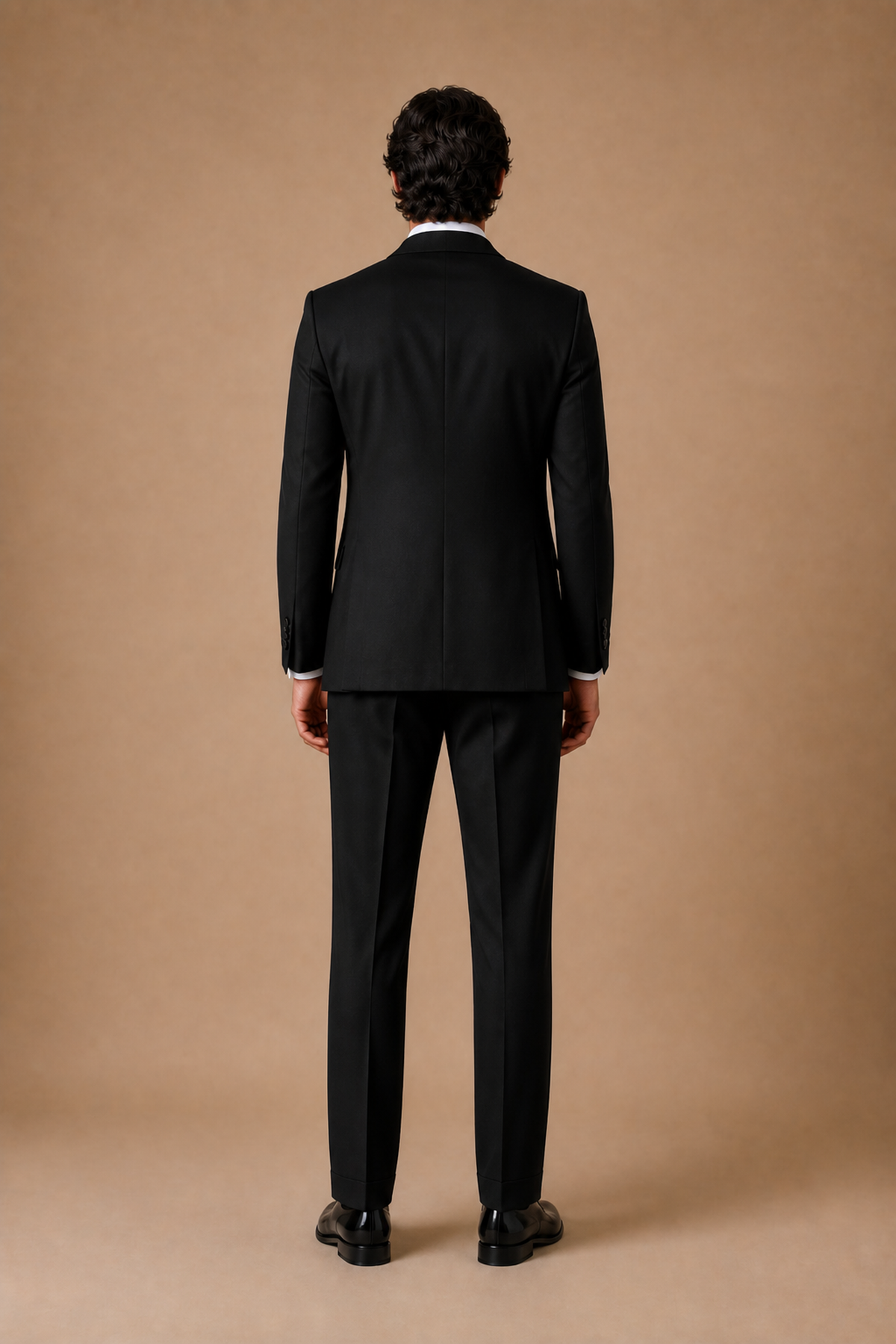 Black modern fit men's tux jacket by Vellor Vault, back view.